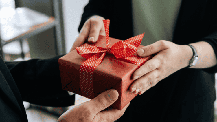 une femme offre un bon cadeau atelier de cuisine les checrets du chef Schmitt